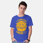 Model wearing royal blue Survivor – Sci-Fi Graphic T-Shirt