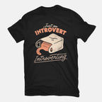 Just An Introvert Introverting – Cat Graphic T-Shirt in black, flat-lay product view